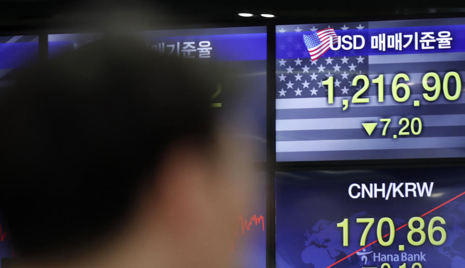 A currency trader works near the screens showing the foreign exchange rates at the foreign exchange dealing room in Seoul, South Korea, Thursday, June 4, 2020. Asian stock markets are mixed after Wall Street rose on better U.S. jobs and manufacturing data than expected. (AP Photo/Lee Jin-man)