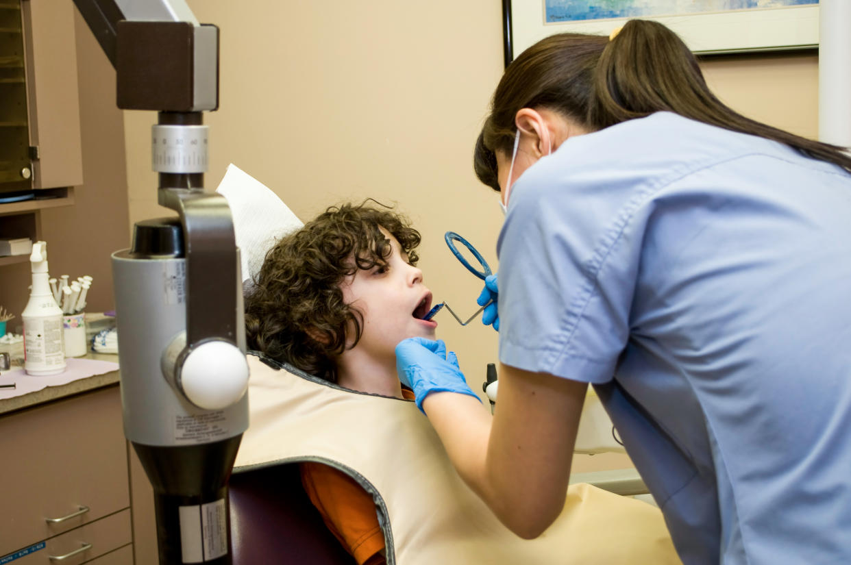 CANADA - 2011/02/28: Hispanic boy in the dentist chair getting prepared for an X-Ray, dentistry office for children. (Photo by Roberto Machado Noa/LightRocket via Getty Images)