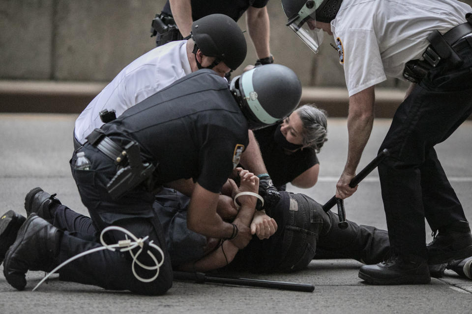 Police arrest a protester refusing to get off the streets during an imposed curfew while marching in a solidarity rally calling for justice over the death of George Floyd Tuesday, June 2, 2020, in New York. Thousands of demonstrators protesting the death of George Floyd remained on New York City streets on Tuesday after an 8 p.m. curfew put in place by officials struggling to stanch destruction and growing complaints that the nation's biggest city was reeling out of control night after night. (AP Photo/Wong Maye-E)