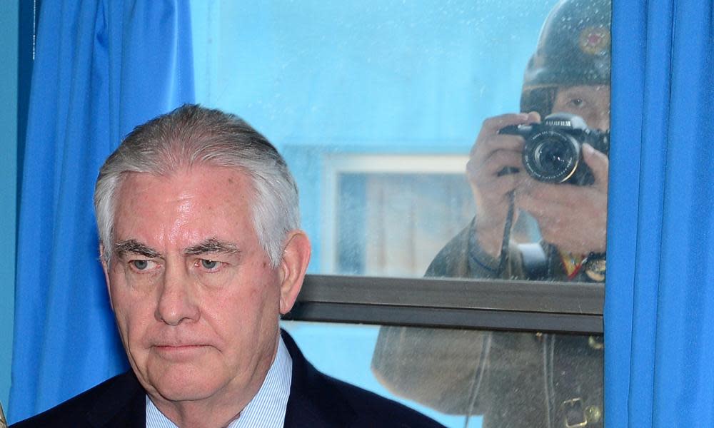 Rex Tillerson is photographed by a North Korean soldier takes a photograph through a window at the border village of Panmunjom, South Korea.