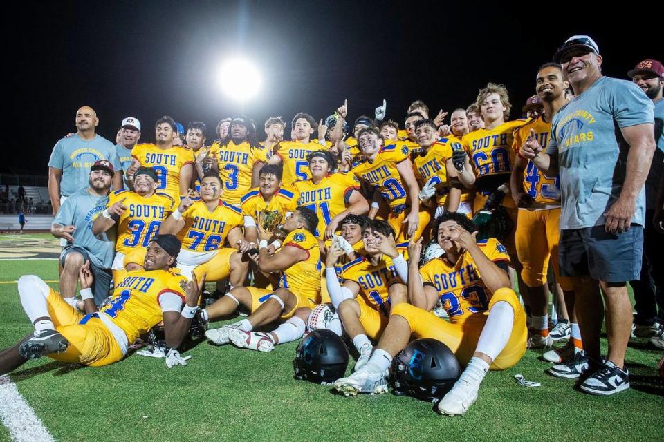 South All-Stars pose for photos with a trophy while celebrating a 33-20 win over the North All-Stars during the Merced County All-Star Football Game at Golden Valley High School in Merced, Calif., on Saturday, June 15, 2024.