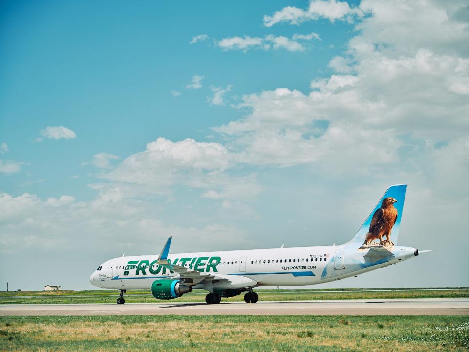 Frontier Airlines aircraft with a bird on the tail.