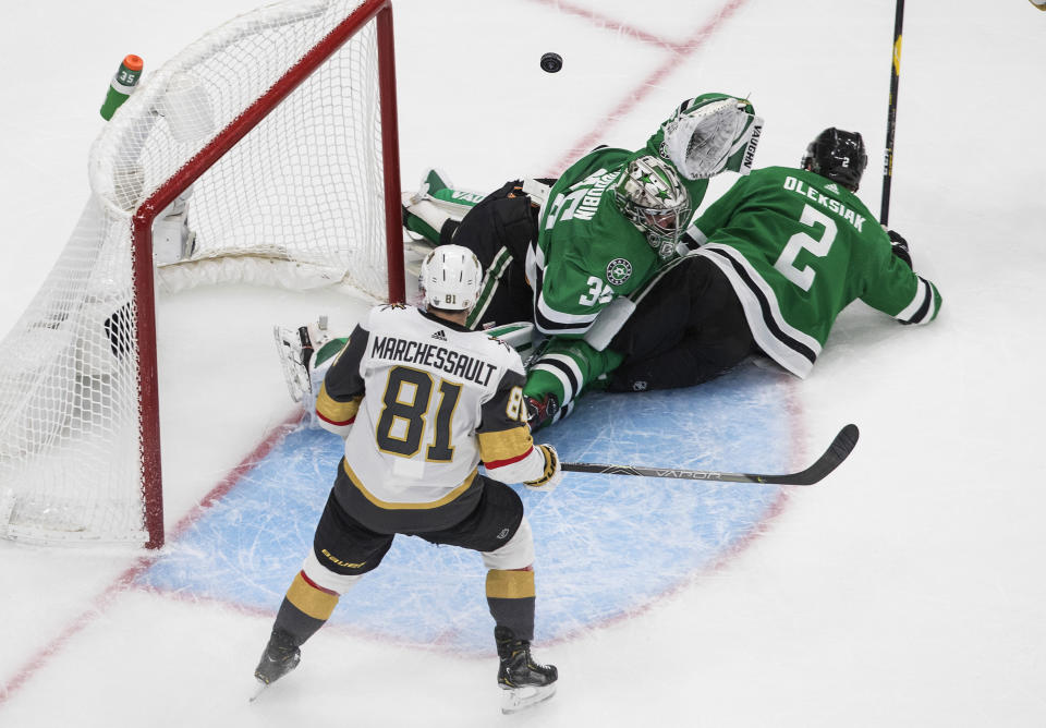 Dallas Stars goalie Anton Khudobin (35) makes the save as Vegas Golden Knights' Jonathan Marchessault (81) looks for the rebound and Stars' Jamie Oleksiak (2) defends during the second period of Game 4 of the NHL hockey Western Conference final, Saturday, Sept. 12, 2020, in Edmonton, Alberta. (Jason Franson/The Canadian Press via AP)