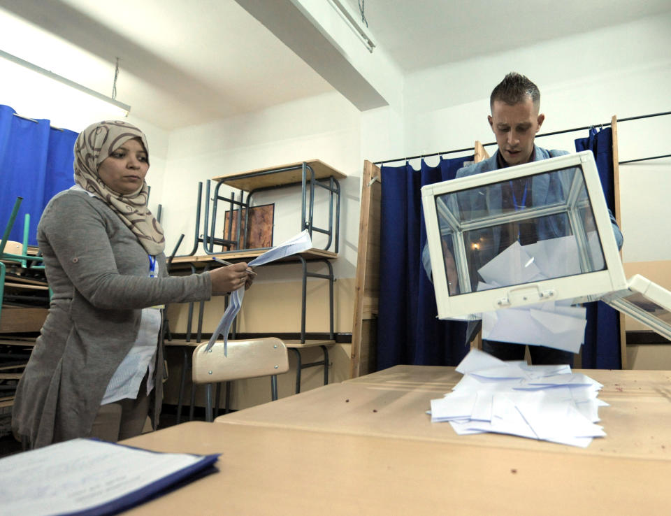 An election worker empties a ballot box during the presidential elections in a polling station in the Algerian capital, Algiers, Thursday, April 17, 2014. Algerians are trickling into the polls to elect a new president of this oil-rich North African nation in an election expected to be won by the ailing incumbent. President Bouteflika has ruled this nation for the past 15 years and, despite suffering from a stroke, is running for a fourth term on a platform of stability. Six candidates are running for the powerful presidency in the April 17 elections. (AP Photo/Sidali djarboub)