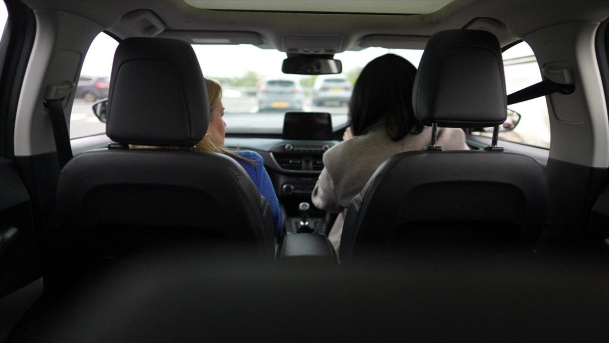 'Lisa' driving with June Kelly in passenger seat