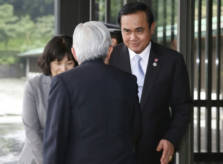 Japan's Emperor Akihito (back to camera) greets Thailand's Prime Minister Prayut Chan-O-Cha (R), at the Imperial Palace in Tokyo, on July 3, 2015