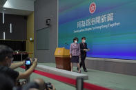 Hong Kong Chief Executive John Lee, right, and convener of the Executive Council Regina Ip leave a news conference in Hong Kong, Tuesday, July 5, 2022. Lee said Tuesday in his first news conference since taking the reins that he will work towards legislating easing restrictions for travelers, but that it must be balanced with limiting the spread of the coronavirus so as not to overwhelm the healthcare system. (AP Photo/Kin Cheung)