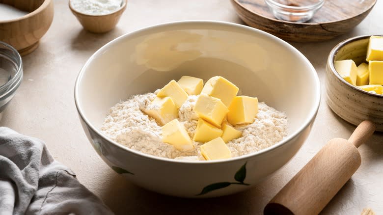 cubes of butter in mixing bowl with flour