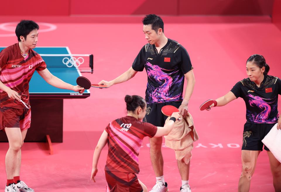 Mizutani Jun 1st L/Ito Mima 2nd L of Japan greet Xu Xin 2nd R/Liu Shiwen of China after winning the table tennis mixed doubles gold medal match at the Tokyo 2020 Olympic Games in Tokyo, Japan, July 26, 2021. (Photo by Zheng Huansong/Xinhua via Getty Images)