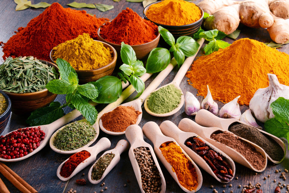 Variety of spices and herbs on kitchen table. (Photo: Getty)