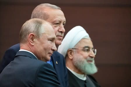 Presidents Hassan Rouhani of Iran, Tayyip Erdogan of Turkey and Vladimir Putin of Russia pose for a picture after a news conference during their meeting in Ankara