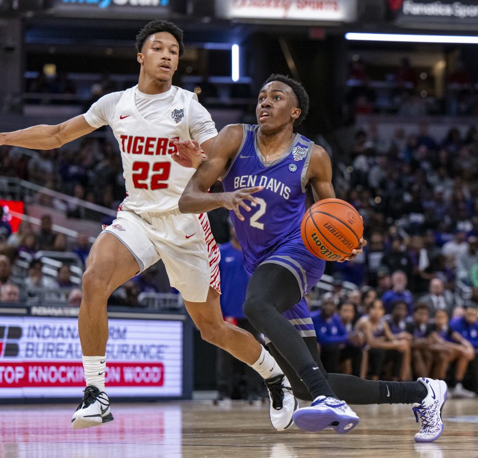 Ben Davis High School junior Mark Zackery IV (2) drives around the defense of Fishers High School junior JonAnthony Hall (22) during the first half of an IHSAA class 4A state championship basketball game, Saturday, March 30, 2024, at Gainbridge Fieldhouse.