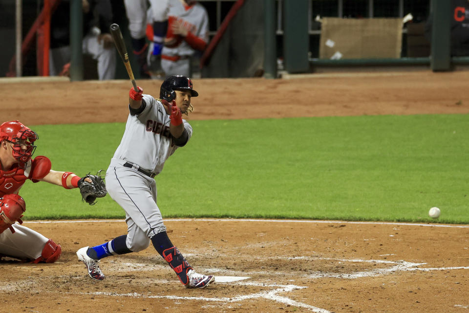 Cleveland Indians' Jose Ramirez hits a single during the fifth inning of a baseball game against the Cincinnati Reds in Cincinnati,Friday, April 16, 2021. (AP Photo/Aaron Doster)