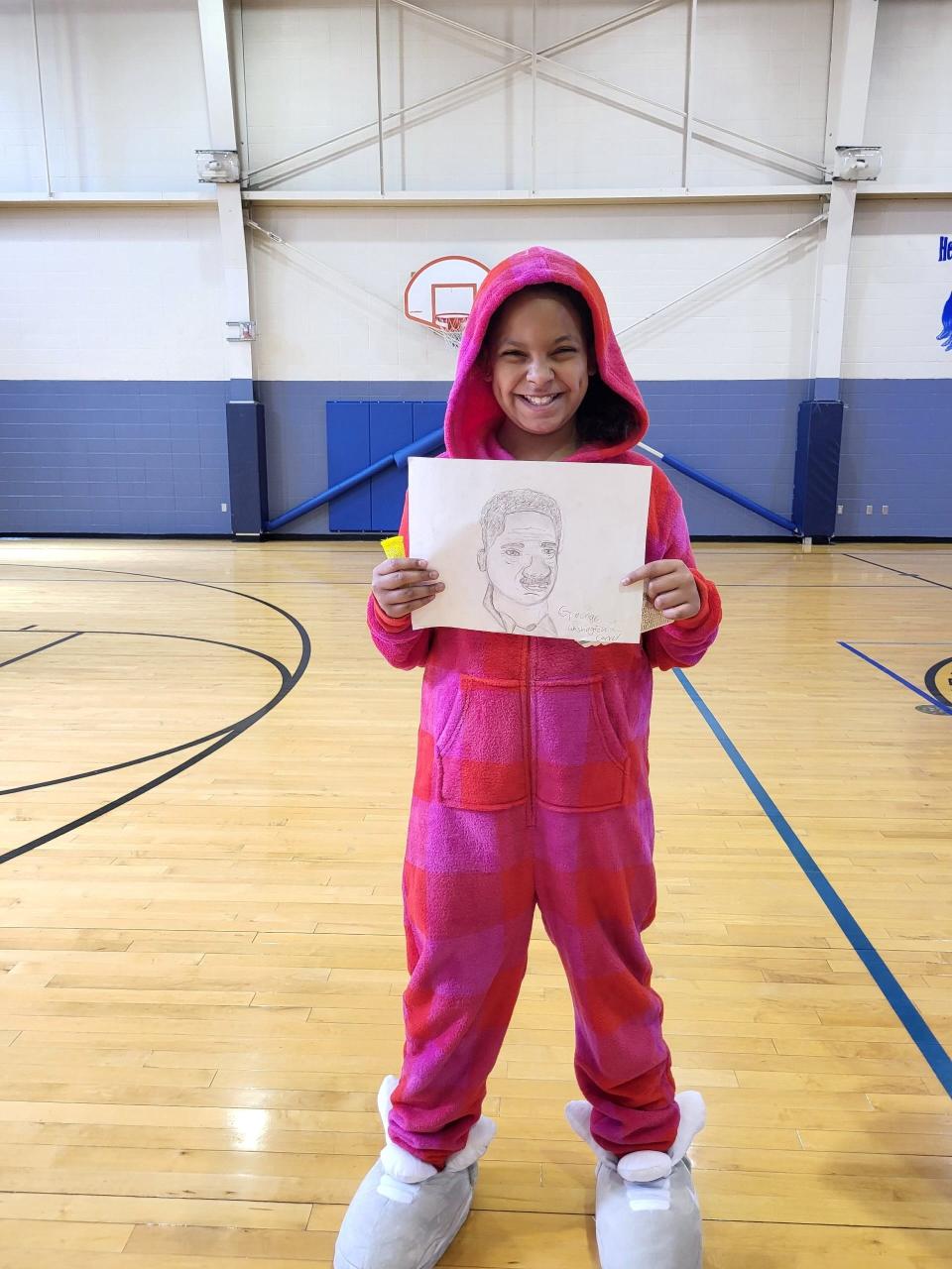 Boys & Girls Club of Springfield member MezMariah E. poses for a photo with her pencil drawing of George Washington Carver. Carver won third place in the sixth annual Boys and Girls Club of Springfield and UScellular Black History Month Art Contest. She received $100 for her third place drawing.