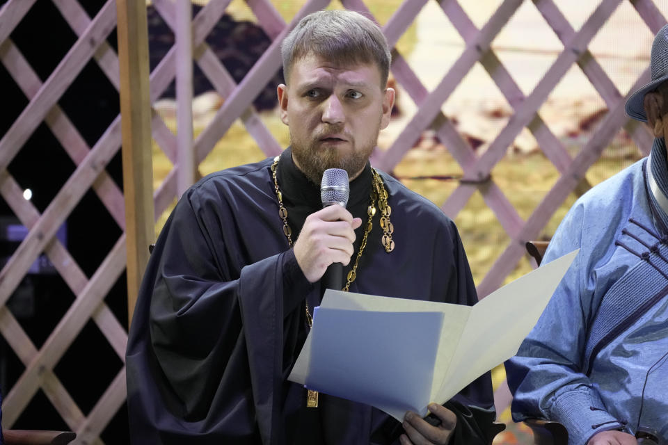 Rector of the only Orthodox church in Mongolia, Father Antony Gusev addresses Pope Francis during a meeting with religious leaders at the Hun Theatre in the Sky Resort compound some 15 kilometers south of the Mongolian capital Ulaanbaatar, Sunday, Sept. 3, 2023. Pope Francis has praised Mongolia's tradition of religious freedom dating to the times of founder Genghis Khan during the first-ever papal visit to the Asian nation. (AP Photo/Andrew Medichini)