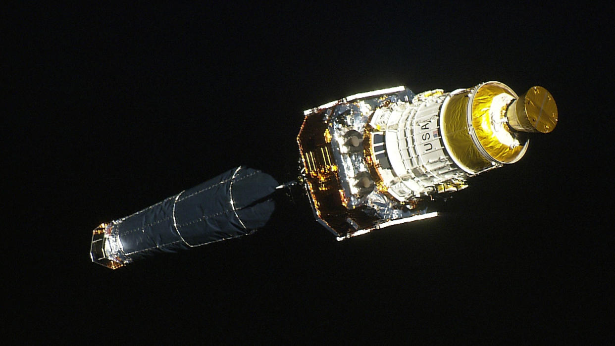 A long spacecraft in space. 