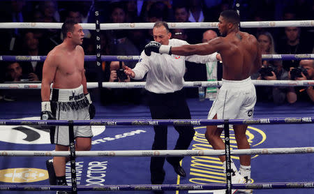 Boxing - Anthony Joshua vs Joseph Parker - World Heavyweight Title Unification Fight - Principality Stadium, Cardiff, Britain - March 31, 2018 Referee Giuseppe Quartarone separates Anthony Joshua and Joseph Parker Action Images via Reuters/Lee Smith