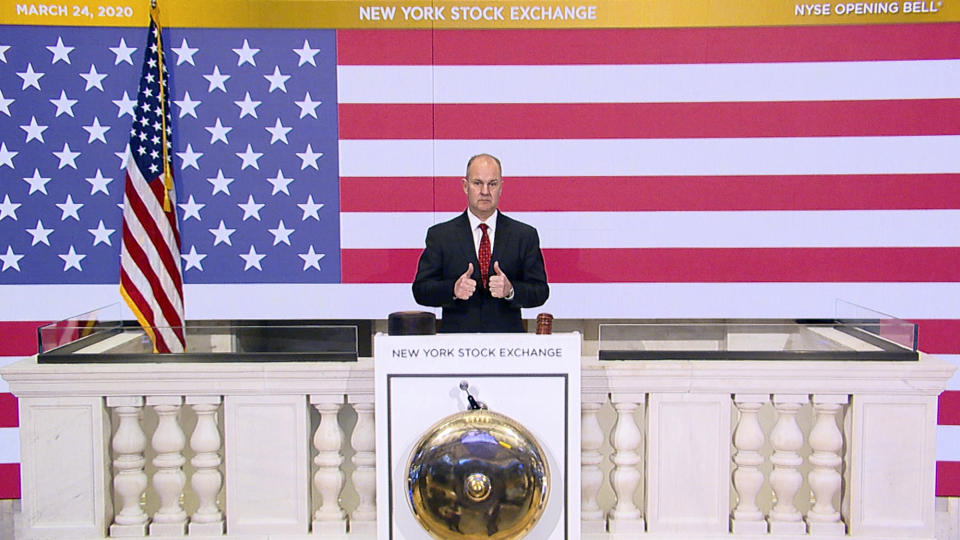 In this photo provided by the New York Stock Exchange, Chief Security Officer Kevin Fitzgibbons rings the opening bell of the NYSE on Tuesday, March 24, 2020. Stocks around the world rallied Tuesday amid expectations that Congress is nearing a deal to pump nearly $2 trillion of aid into the coronavirus-ravaged economy. (New York Stock Exchange via AP)