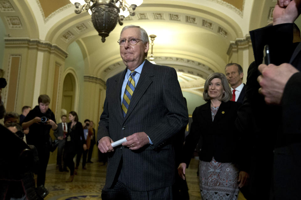 Senate Majority Leader Mitch McConnell, R-Ky., walks to talk with reporters outside of the Senate chamber, on Capitol Hill in Washington, Tuesday, Jan. 14, 2020. (AP Photo/Jose Luis Magana)