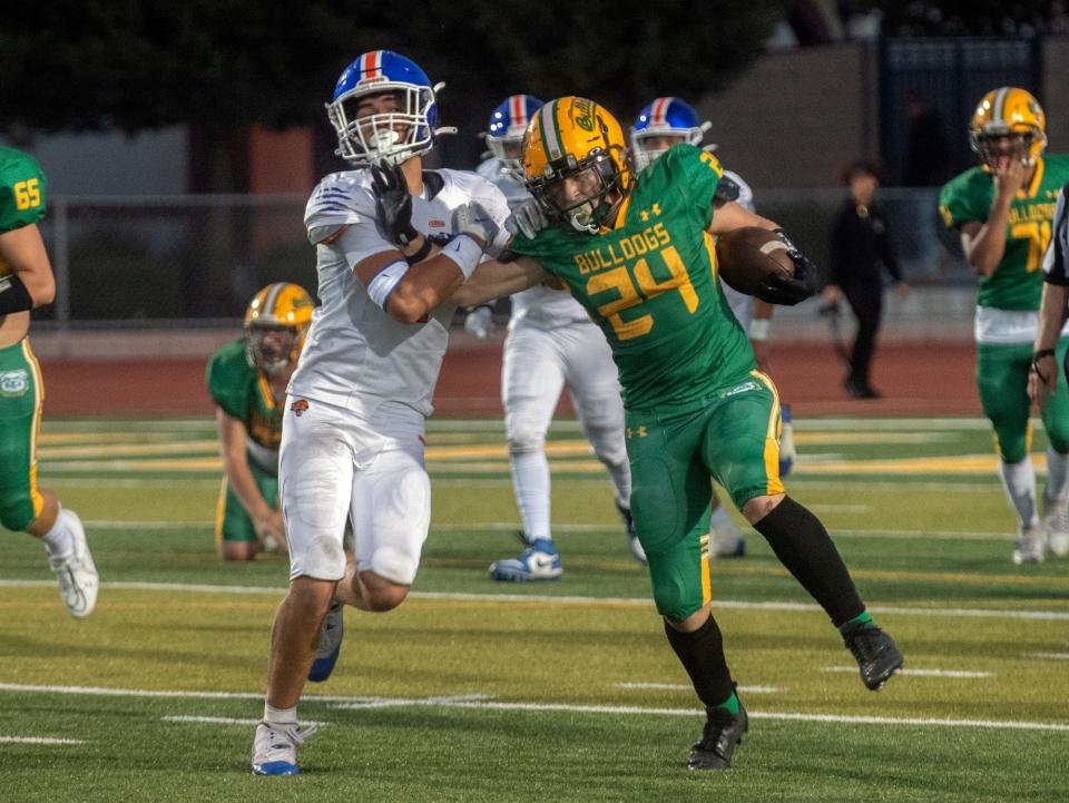 Tracy's Tommy Hayes, right, tries to fend off Kimball's Jacob Salazar during a varsity football game at Tracy's Wayne Schneider Stadium in Tracy.