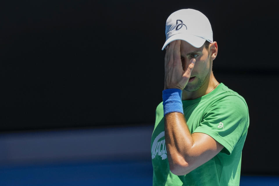 FILE - Defending men's champion Serbia's Novak Djokovic practices on Margaret Court Arena ahead of the Australian Open tennis championship in Melbourne, Australia, on Jan. 13, 2022. Tennis star Djokovic faces deportation again after the Australian government revoked his visa for a second time. Immigration Minister Alex Hawke said Friday, Jan. 14, he used his ministerial discretion to revoke the 34-year-old Serb’s visa on public interest grounds three days before the Australian Open is to begin.(AP Photo/Mark Baker, File)