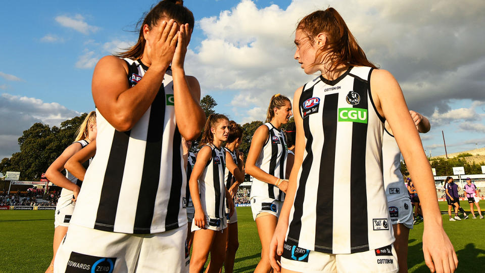 Collingwood players, pictured here after a loss in the AFLW.