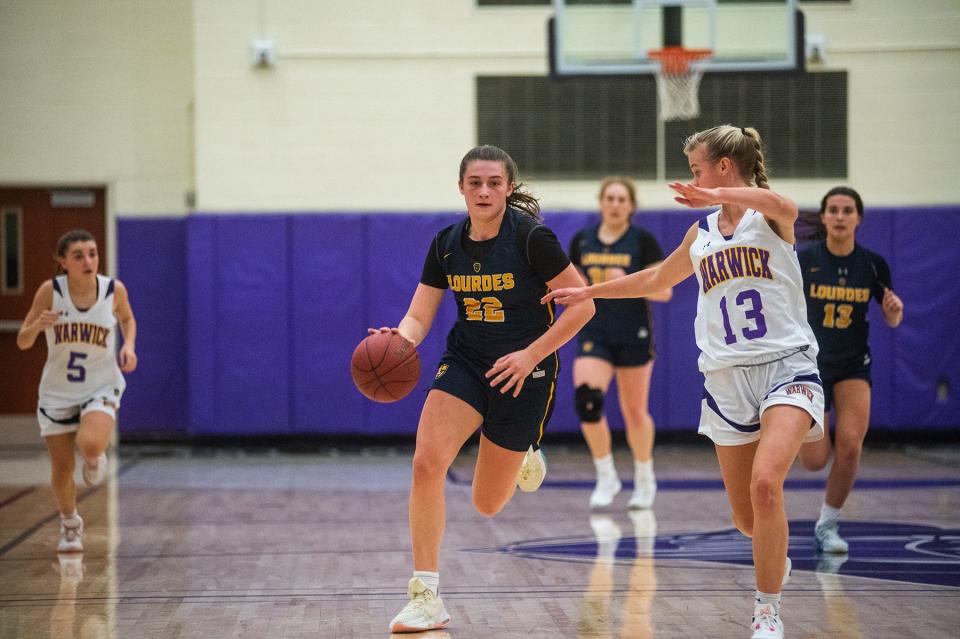 Lourdes' Simone Pelish, left, drives up court with Warwick's Kaitlyn Larney in tow during the Section 9 BCANY Coaches vs Cancer tournament at Monroe-Woodbury High School in Central Valley, NY on Saturday, January 7, 2023. Warwick defeated Lourdes. KELLY MARSH/FOR THE TIMES HERALD-RECORD