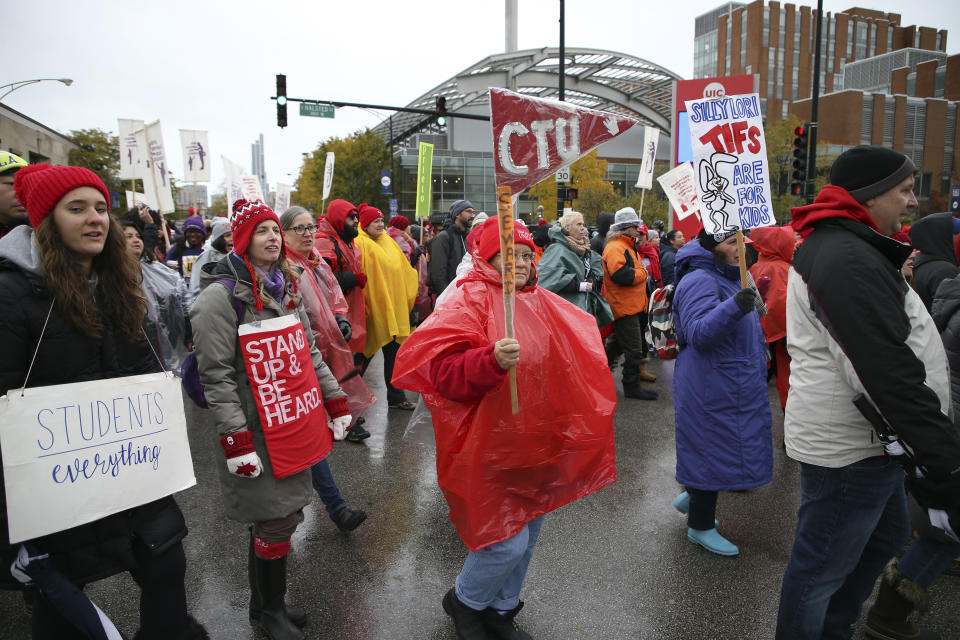 As a strike by public school teachers continues, Chicago Teachers Union members and their supporters march to Roosevelt Road and Halsted Street in Chicago on Wednesday, Oct. 30, 2019. Chicago's teachers union voted to approve a tentative contract agreement with city officials Wednesday but refused to end a strike that has canceled two weeks of classes unless the city's mayor adds school days to cover that lost time. (Terrence Antonio James/Chicago Tribune via AP)