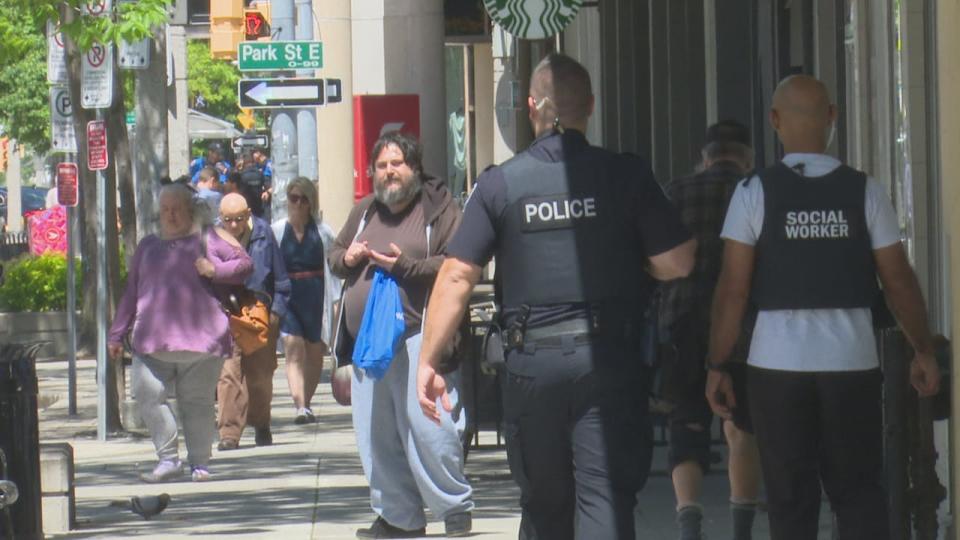 A Windsor police officer and a social worker patrolling in downtown Windsor on May 8, 2024.
