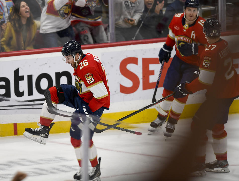 Florida Panthers defenseman Uvis Balinskis (26) celebrates after scoring his first NHL goal during the first period of a hockey game against the Carolina Hurricanes, Friday, Nov. 10, 2023, in Sunrise, Fla. (AP Photo/Michael Laughlin)
