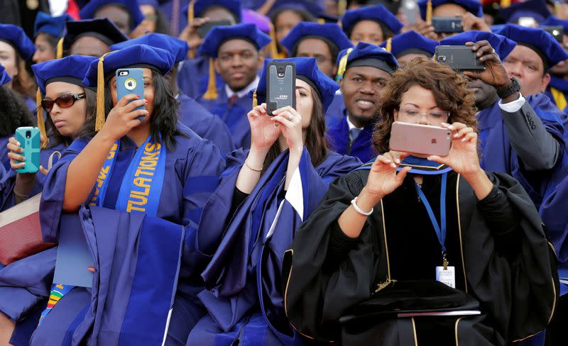 FILE PHOTO: Students photograph U.S. President Barack Obama with their phones as he delivers the commencement address to the 2016 graduating class of Howard University in Washington