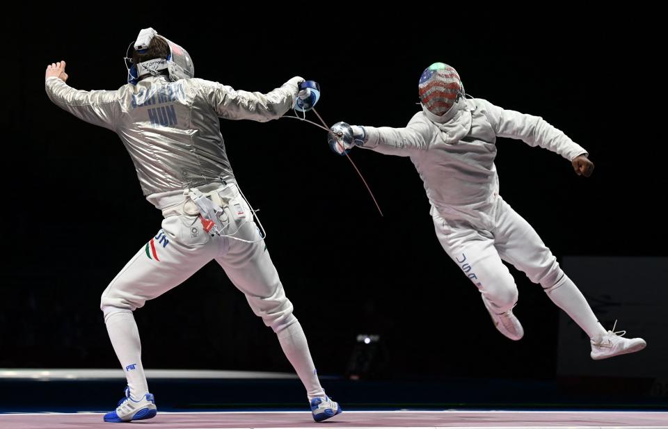 <p>Hungary's Andras Szatmari (L) compete against USA's Daryl Homer in the men's sabre team quarter-final bout during the Tokyo 2020 Olympic Games at the Makuhari Messe Hall in Chiba City, Chiba Prefecture, Japan, on July 28, 2021. (Photo by Mohd RASFAN / AFP)</p> 