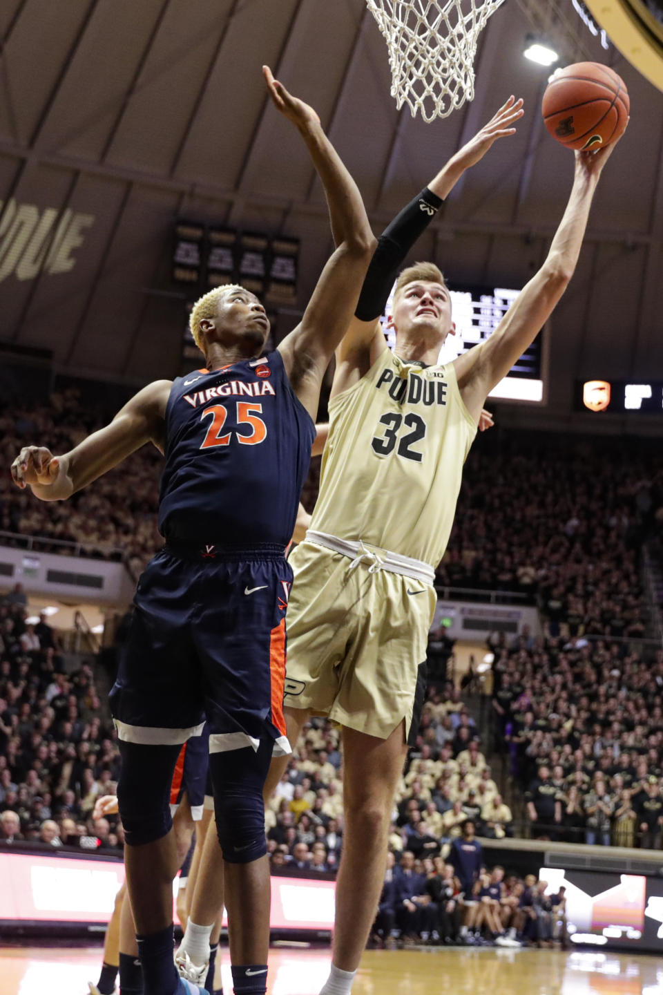 Purdue center Matt Haarms (32) shoots next to Virginia forward Mamadi Diakite (25) during the second half of an NCAA college basketball game in West Lafayette, Ind., Wednesday, Dec. 4, 2019. Purdue won 69-40. (AP Photo/Michael Conroy)