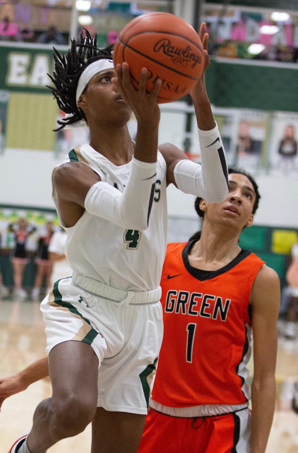 GlenOak's Jaylen McElroy, driving to the hoop against Green last season, is expected to make an impact on the football field this fall.