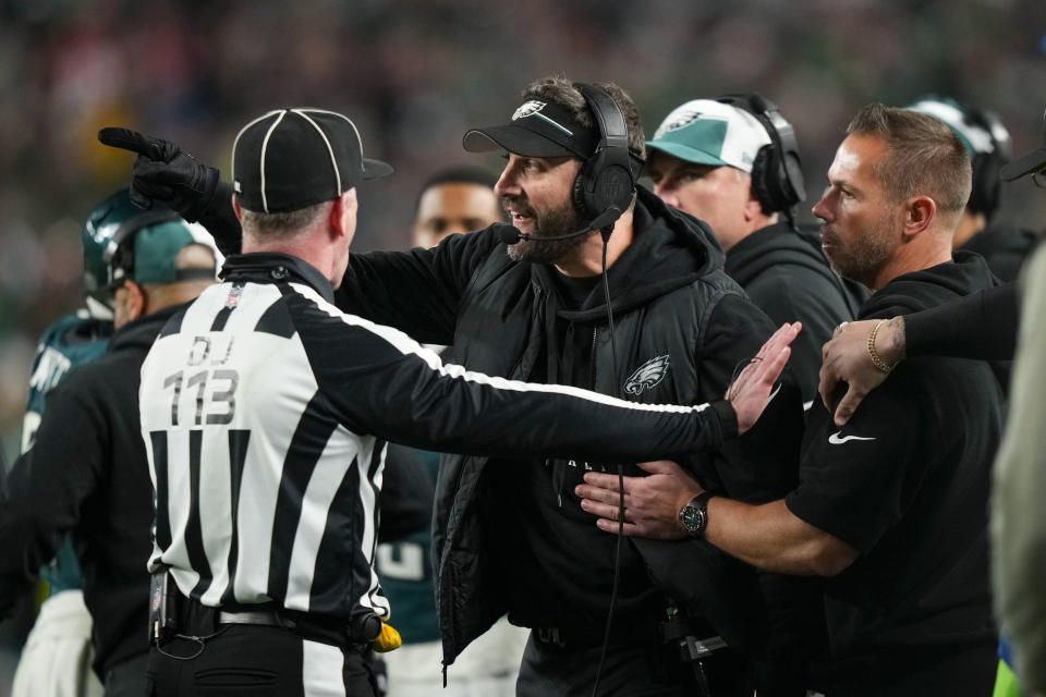 Philadelphia Eagles head coach Nick Sirianni, center, talks with down judge Danny Short (113) during the second half of an NFL football game against the San Francisco 49ers, Sunday, Dec. 3, 2023, in Philadelphia. (AP Photo/Matt Slocum)