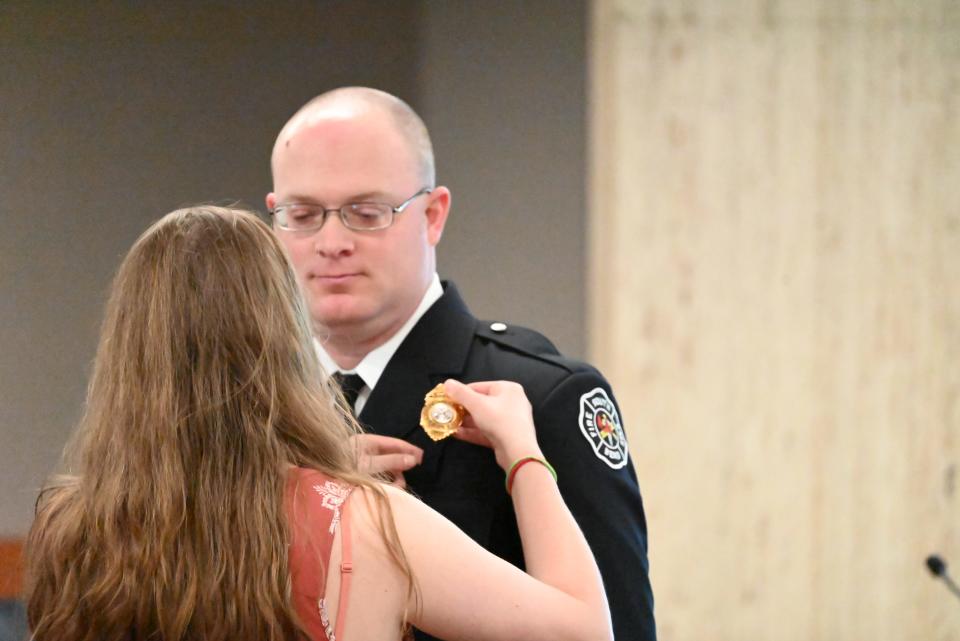 Jon Knepp receives a promotion to the rank of captain on April 17, 2024, approved by the Board of Public Safety and is pinned by his wife.