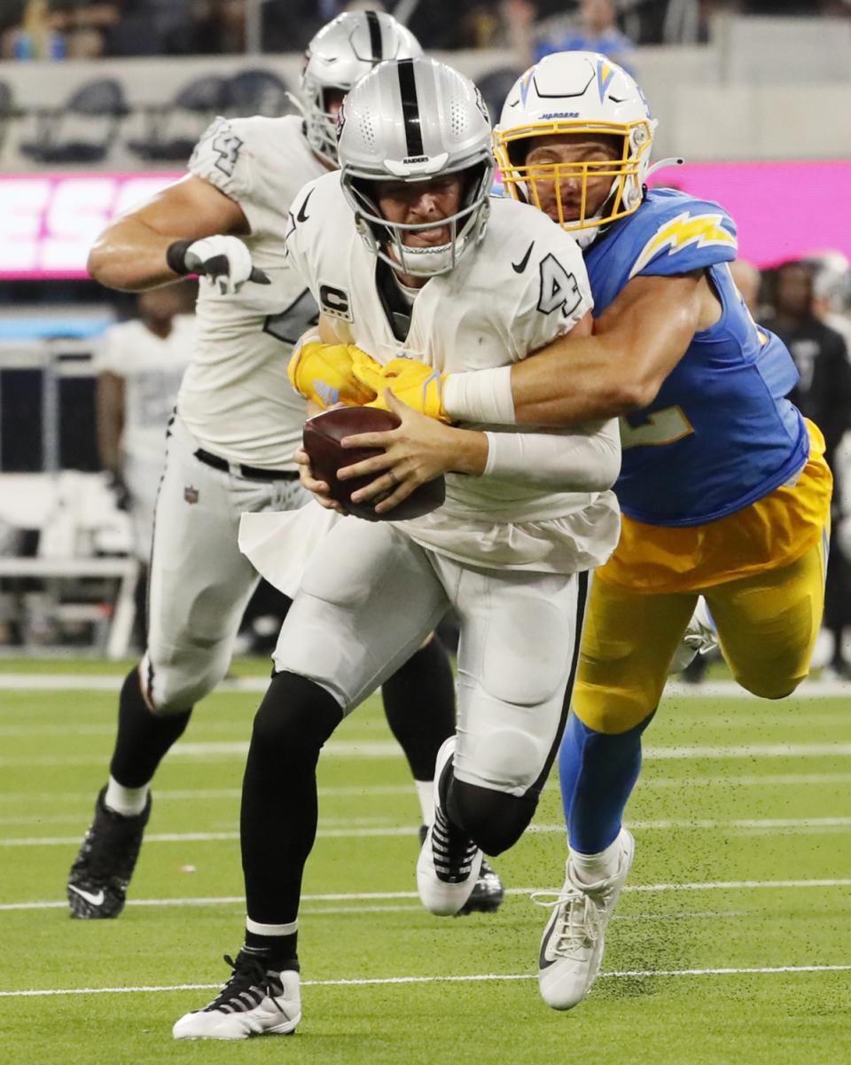 Chargers linebacker Kyler Fackrell tackles Raiders quarterback Derek Carr from behind for a second-half sack.