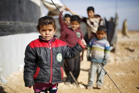 Syrian refugee children pose as they play near their families' residence at Al Zaatari refugee camp in the Jordanian city of Mafraq, near the border with Syria, January 30, 2016. REUTERS/ Muhammad Hamed