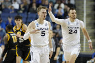 Xavier guard Adam Kunkel celebrates after scoring against Pittsburgh during the first half of a second-round college basketball game in the NCAA Tournament on Sunday, March 19, 2023, in Greensboro, N.C. (AP Photo/Chris Carlson)