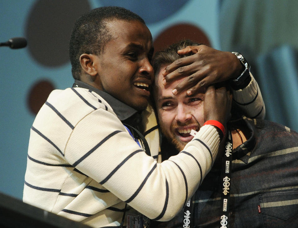 Cutter Hodierne, right, director of "Fishing Without Nets," is embraced by cast member Abdikani Muktar after winning the Directing Award: Dramatic for his film during the 2014 Sundance Film Festival Awards Ceremony on Saturday, Jan. 25, 2014, in Park City, Utah. (Photo by Chris Pizzello/Invision/AP)