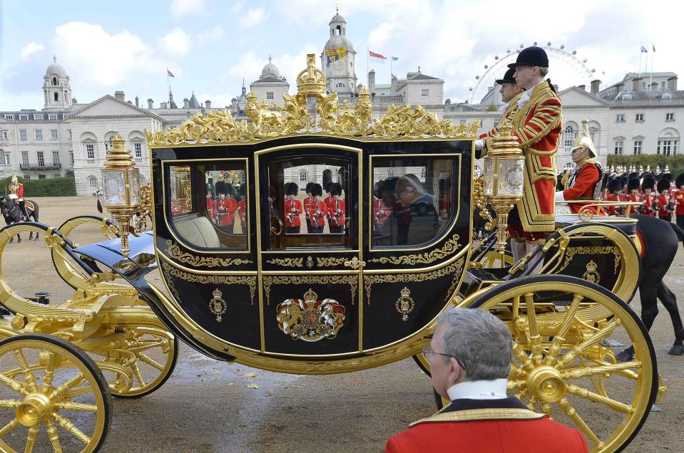 The President of Singapore Tony Tan leaves in a carriage with Britain's Queen Elizabeth after attending a ceremonial welcome at Horse Guards Parade in London