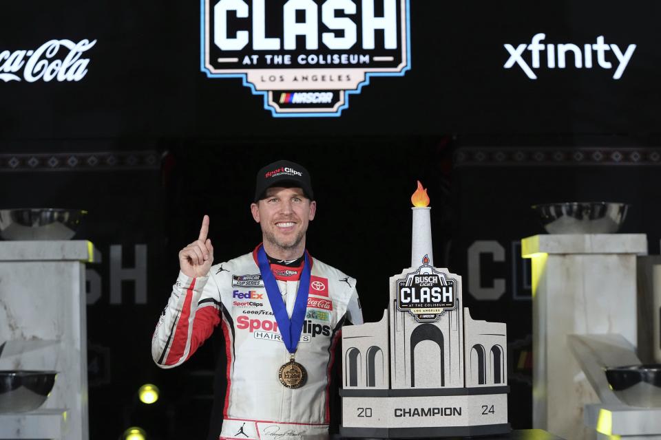 Denny Hamlin poses with his troph after winning the Busch Light Clash NASCAR exhibition auto race at Los Angeles Memorial Coliseum Saturday, Feb. 3, 2024, in Los Angeles. (AP Photo/Mark J. Terrill)