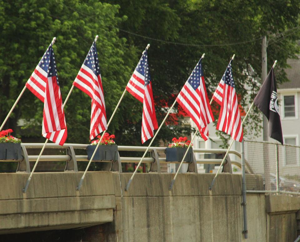 Flags line the Mill Street bridge in observance of Memorial Day.