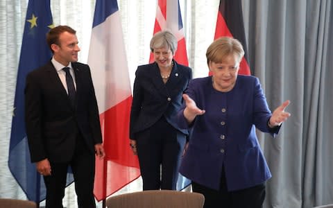 French President Emmanuel Macron, British Prime Minister Theresa May and German Chancellor Angela Merkel smile arrive for the start of an EU-Western Balkans Summit in Sofia on May 17, 2018 - Credit: LUDOVIC MARIN/AFP