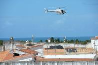 A National Security helicopter overflies the Alcacuz Penitentiary Center where members of the special police battalion entered to regain control of the penitentiary in Rio Grande do Norte, Brazil, on January 18, 2017