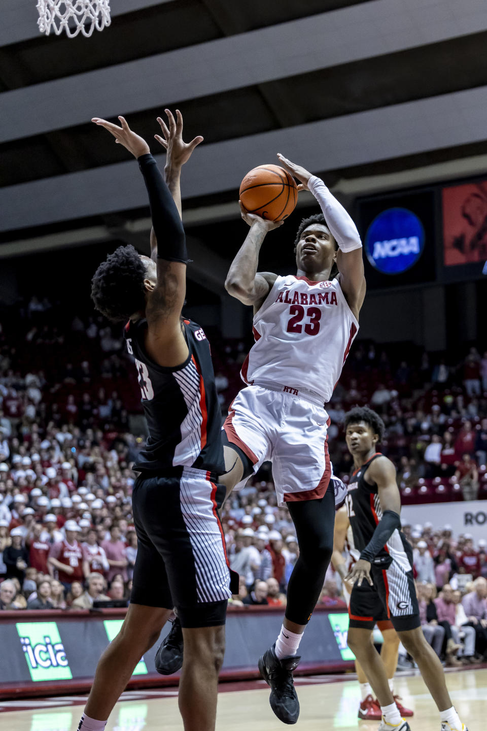 Alabama forward Nick Pringle (23) shoots over Georgia center Braelen Bridges (23) during the second half of an NCAA college basketball game Saturday, Feb. 18, 2023, in Tuscaloosa, Ala. (AP Photo/Vasha Hunt)