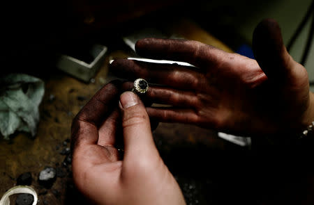 Jeweller Katarzyna Depa, 26, who makes jewellery from coal, holds a silver ring with coal at her atelier in Katowice, Poland, November 26, 2018. REUTERS/Kacper Pempel