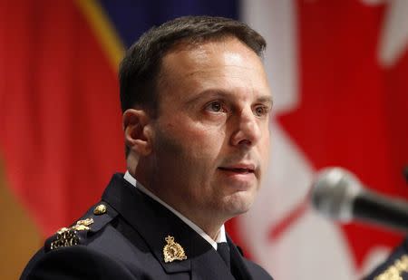 RCMP Assistant Commissioner James Malizia speaks at a press conference at RCMP headquarters after announcing terror-related charges have been laid against three men in Ottawa, February 3, 2015. REUTERS/Patrick Doyle