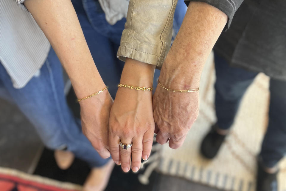 This undated photo provided by Marisa Ellman shows Maya Brook, Marisa Ellman and Debbie Ellman after they purchased permanent jewelry at Love Saro in Boulder, Colo. (Marisa Ellman via AP)