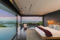 The mid-century mansion has floor-to-ceiling glass that gives a 180 degree view of Los Angeles.